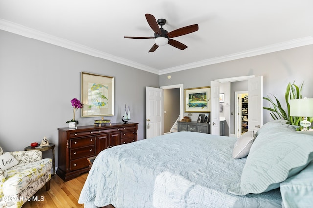 bedroom featuring crown molding, a ceiling fan, and light wood-type flooring