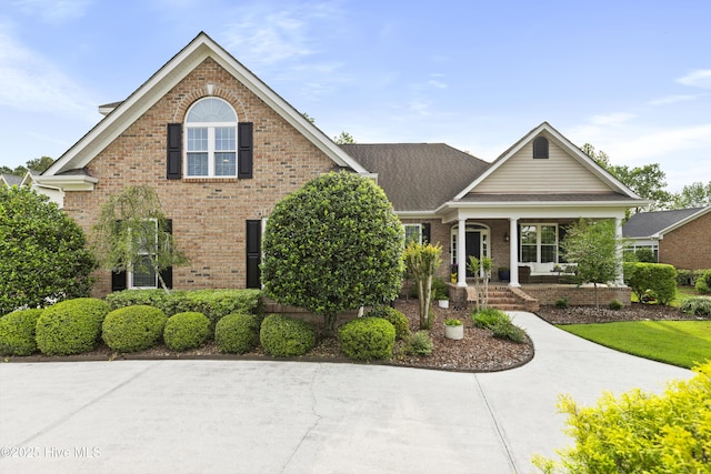 view of front of house with brick siding and covered porch
