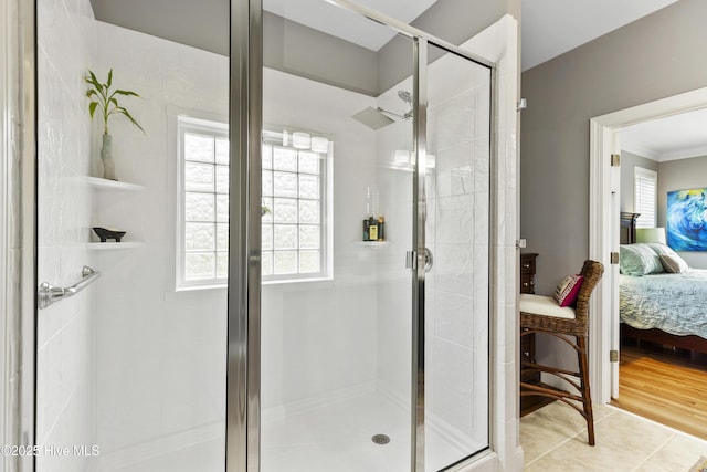 bathroom with crown molding, ensuite bathroom, and a stall shower