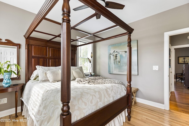 bedroom with baseboards and light wood finished floors