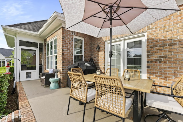 view of patio with outdoor dining area and area for grilling