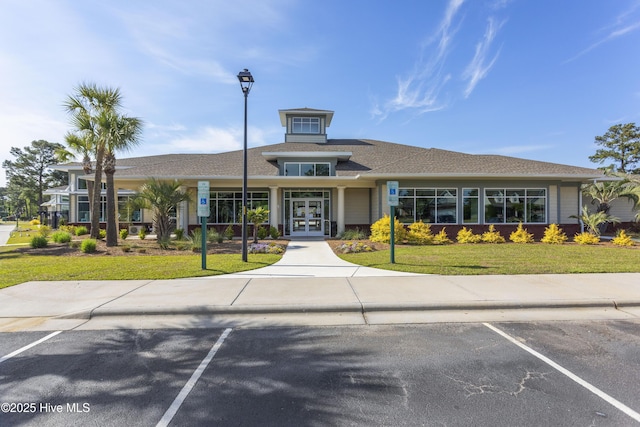 view of building exterior with uncovered parking