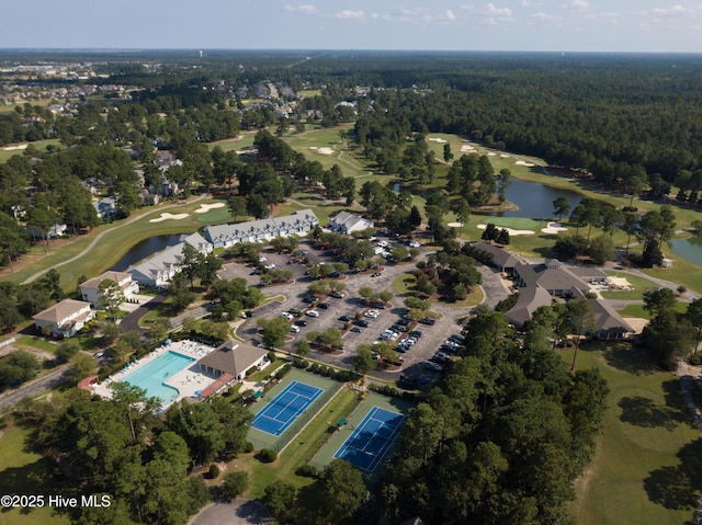 aerial view featuring a forest view, a water view, and golf course view
