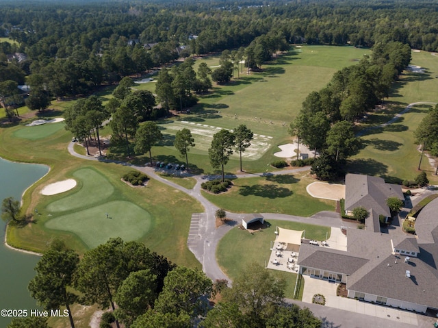 drone / aerial view featuring a water view, a view of trees, and view of golf course