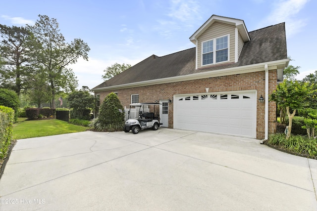 view of property exterior with roof with shingles, a yard, driveway, and brick siding
