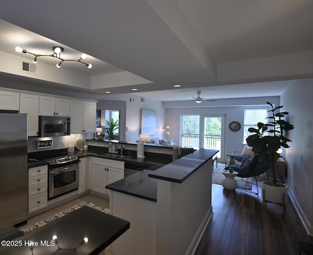 3100 Marsh Grove Ln Unit 3212, Southport, NC 28461 - kitchen with appliances with stainless steel finishes, dark countertops, white cabinets, open floor plan, and recessed lighting