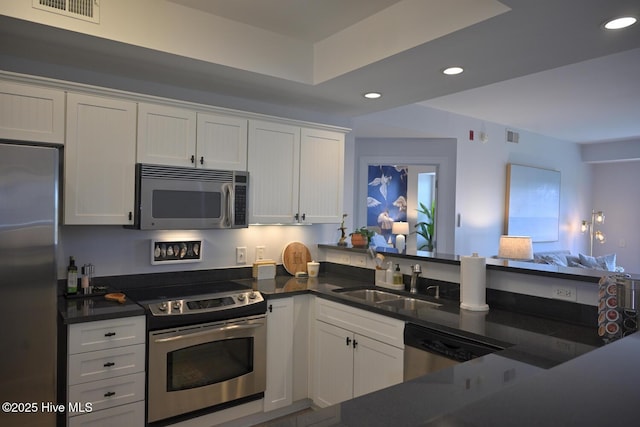3100 Marsh Grove Ln Unit 3212, Southport, NC 28461 - kitchen with appliances with stainless steel finishes, a sink, dark countertops, recessed lighting, and white cabinets