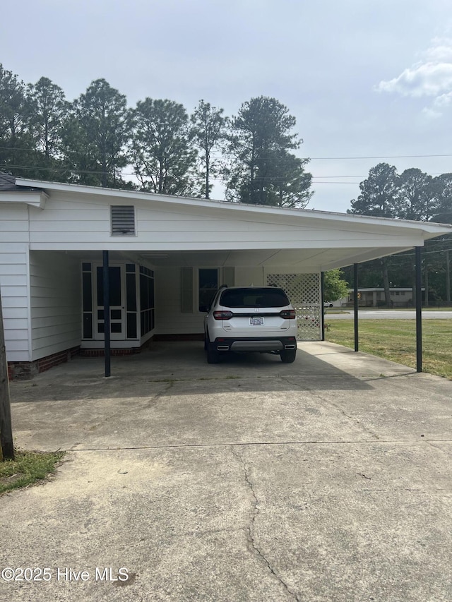 view of parking featuring driveway and an attached carport