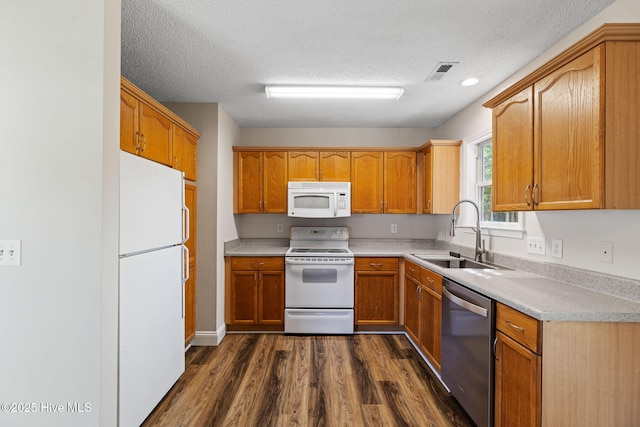 719 Oak Branches Close Close SE, Leland, NC 28451 - kitchen with white appliances, a sink, dark wood-style flooring, light countertops, and a textured ceiling