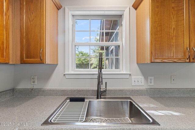 719 Oak Branches Close Close SE, Leland, NC 28451 - kitchen with a sink, plenty of natural light, light countertops, and brown cabinetry