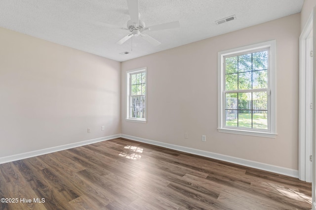 719 Oak Branches Close Close SE, Leland, NC 28451 - empty room with dark wood-style floors, baseboards, a textured ceiling, and ceiling fan