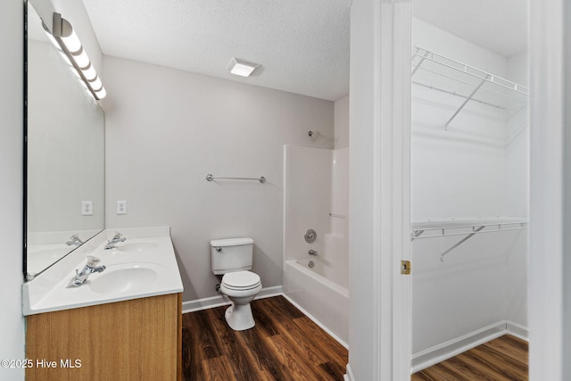 719 Oak Branches Close Close SE, Leland, NC 28451 - bathroom featuring double vanity, toilet, shower / tub combination, and wood finished floors