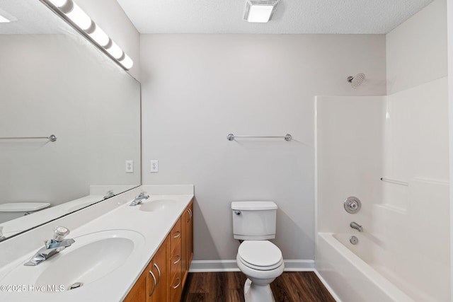719 Oak Branches Close Close SE, Leland, NC 28451 - bathroom featuring toilet, wood finished floors, double vanity, tub / shower combination, and baseboards