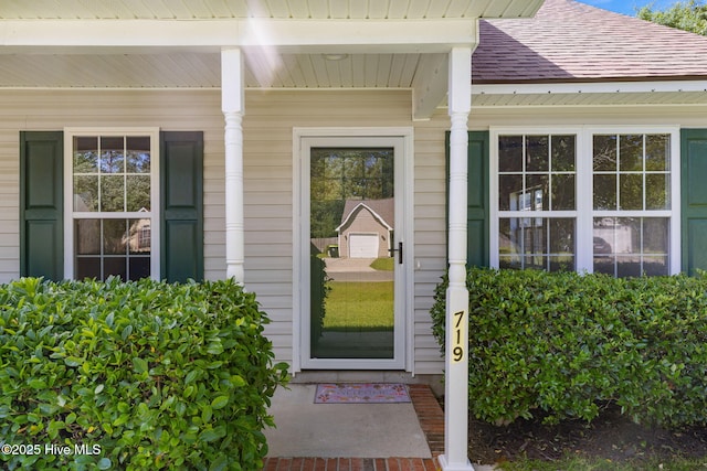 719 Oak Branches Close Close SE, Leland, NC 28451 - view of exterior entry with a shingled roof and covered porch