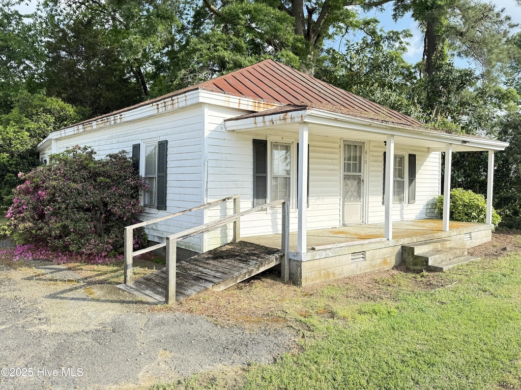 view of front of home with a porch, a standing seam roof, and metal roof