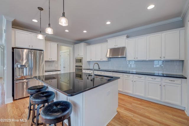 1012 Anchors Bend Way, Wilmington, NC 28411 - kitchen featuring a sink, stainless steel appliances, under cabinet range hood, white cabinetry, and dark countertops