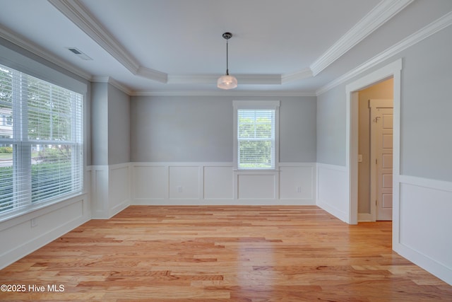 1012 Anchors Bend Way, Wilmington, NC 28411 - unfurnished room with light wood-style floors, a tray ceiling, visible vents, ornamental molding, and wainscoting