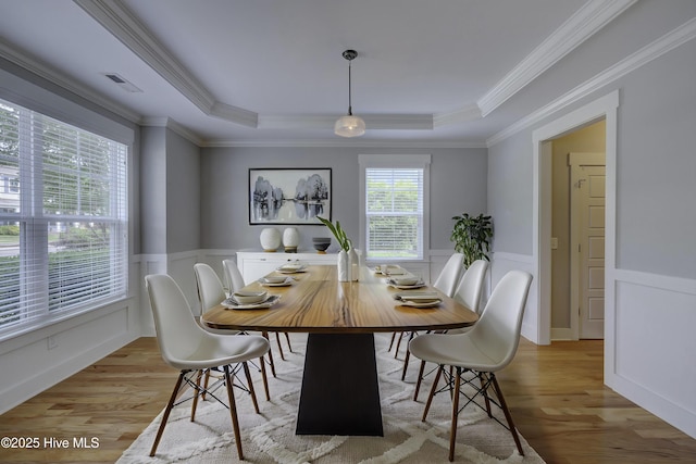 1012 Anchors Bend Way, Wilmington, NC 28411 - dining room featuring ornamental molding, light wood finished floors, visible vents, and a tray ceiling