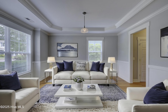 1012 Anchors Bend Way, Wilmington, NC 28411 - living room with wood finished floors, ornamental molding, a wainscoted wall, visible vents, and a tray ceiling