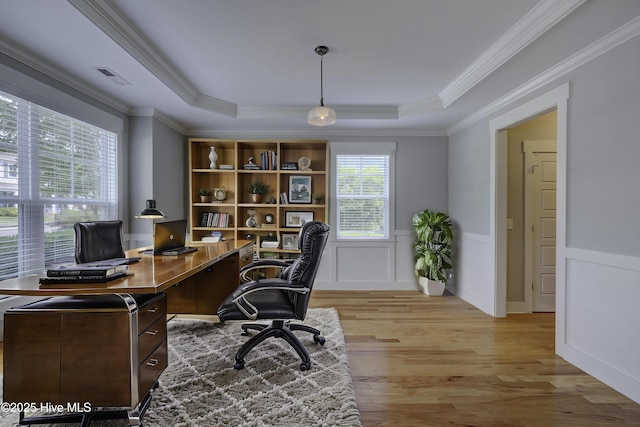 1012 Anchors Bend Way, Wilmington, NC 28411 - home office featuring light wood-style flooring, visible vents, a raised ceiling, a wainscoted wall, and ornamental molding