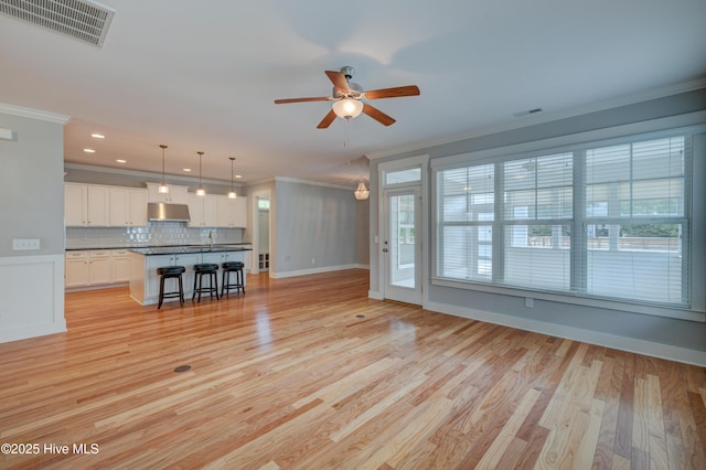 1012 Anchors Bend Way, Wilmington, NC 28411 - unfurnished living room with visible vents, ceiling fan, crown molding, and baseboards