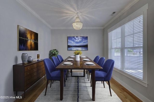 1012 Anchors Bend Way, Wilmington, NC 28411 - dining room with baseboards, wood finished floors, a notable chandelier, and crown molding