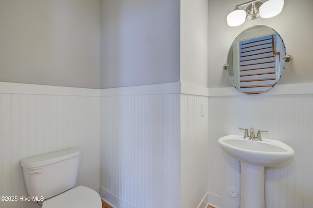 1012 Anchors Bend Way, Wilmington, NC 28411 - bathroom with toilet, a wainscoted wall, and a sink