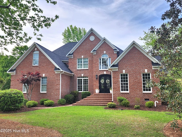 view of front facade with brick siding, crawl space, and a front yard