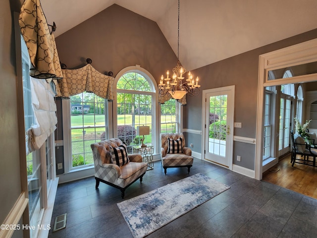 sitting room featuring a chandelier, high vaulted ceiling, visible vents, and plenty of natural light