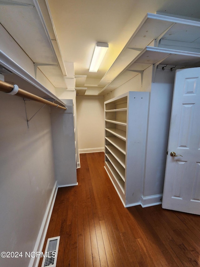 walk in closet with visible vents and wood-type flooring