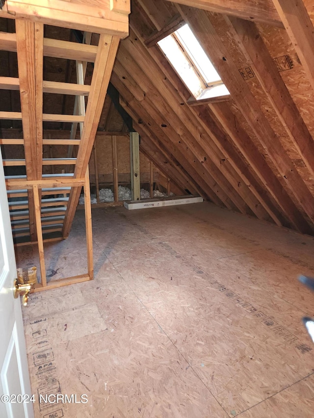attic featuring a skylight