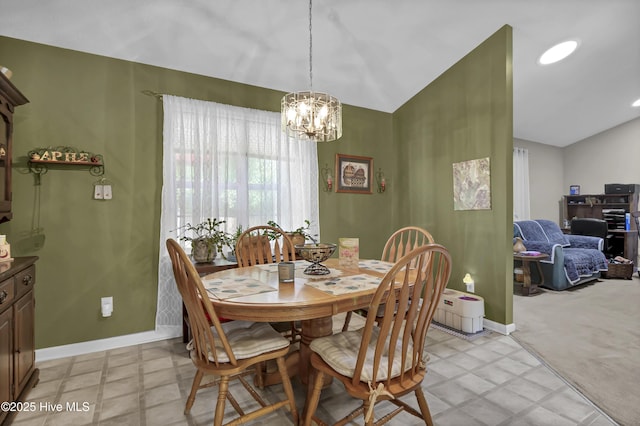 dining space featuring lofted ceiling, a chandelier, and baseboards