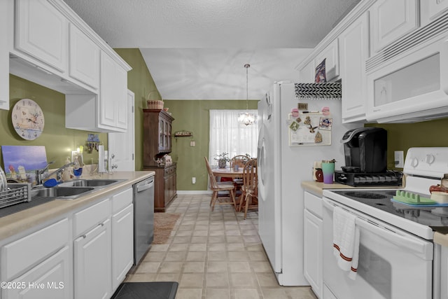 kitchen featuring white appliances, white cabinets, a chandelier, light countertops, and a textured ceiling
