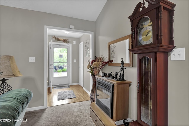 foyer featuring carpet floors and baseboards