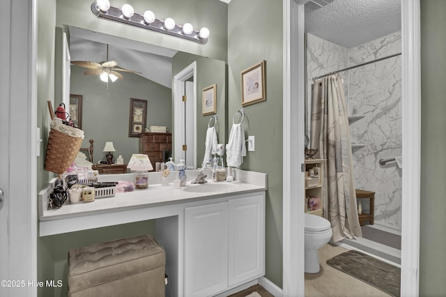 full bathroom with a stall shower, toilet, vanity, ceiling fan, and a textured ceiling