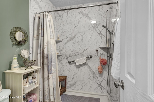 bathroom featuring a marble finish shower