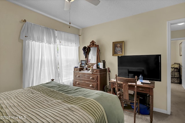 bedroom featuring carpet flooring, a textured ceiling, ceiling fan, and baseboards