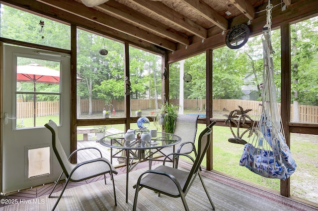 sunroom with outdoor dining area
