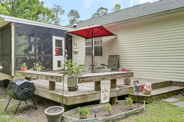 wooden deck with a sunroom