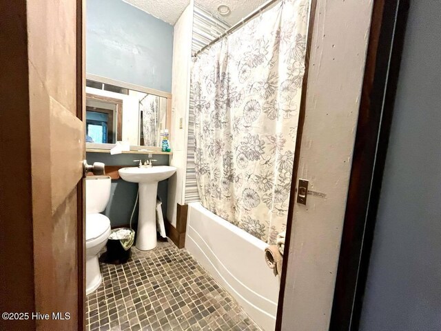 1281 Old Chinquapin Rd, Beulaville, NC 28518 - bathroom with toilet, tile patterned floors, a sink, shower / bathtub combination with curtain, and a textured ceiling