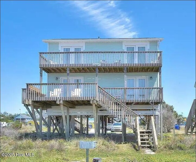 rear view of property with stairway