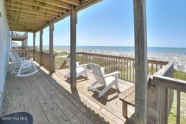 wooden terrace with a beach view and a water view