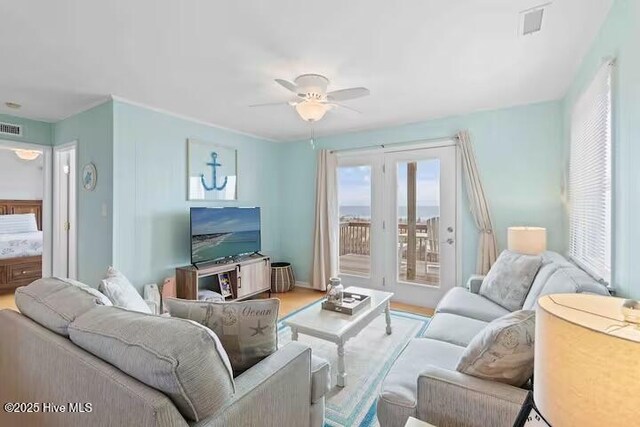living room with light wood-type flooring and a ceiling fan