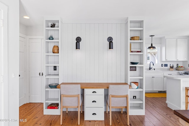 interior space featuring light countertops, white cabinets, open shelves, and light wood-type flooring