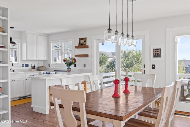 dining space featuring an inviting chandelier, plenty of natural light, light wood-style flooring, and visible vents