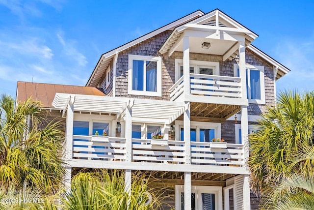 view of front of house with french doors and a balcony