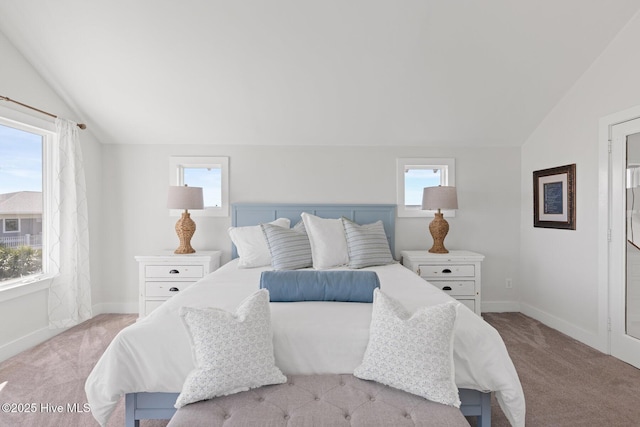 carpeted bedroom featuring baseboards and lofted ceiling