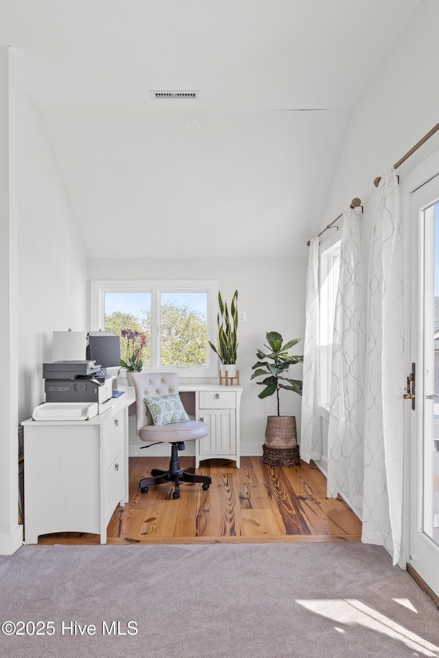 office area featuring visible vents, wood finished floors, and vaulted ceiling