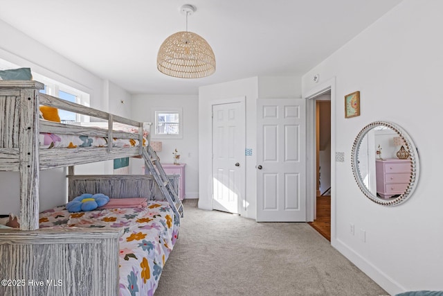bedroom featuring baseboards and carpet