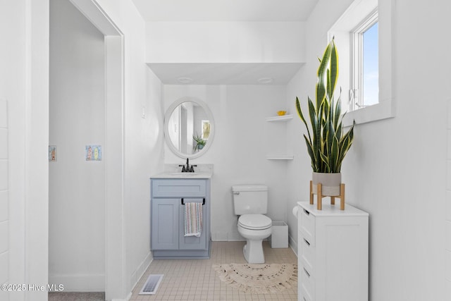 bathroom featuring vanity, tile patterned floors, toilet, and visible vents